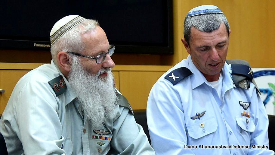 Rabbi Col. Eyal Karim (left), nominated to become IDF chief rabbi, sits next to his predecessor, Brig. Gen. Rafi Peretz, on April 21, 2016