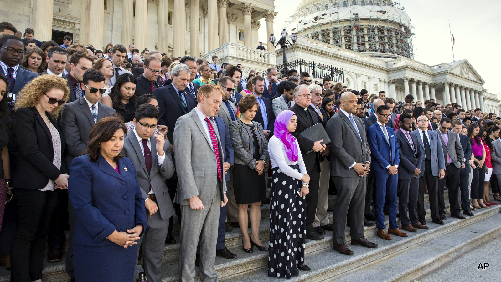 The LGBT Congressional Staff Association, the Congressional Muslim Staff Association, and members of Congress gather for a prayer and moment of silence on the steps of the Capitol in Washington, Monday, June 13, 2016.