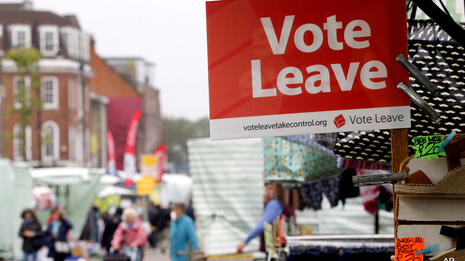 A Vote Leave sign is fixed on a market stall at Havering's Romford street market in London, Wednesday, June 1, 2016.