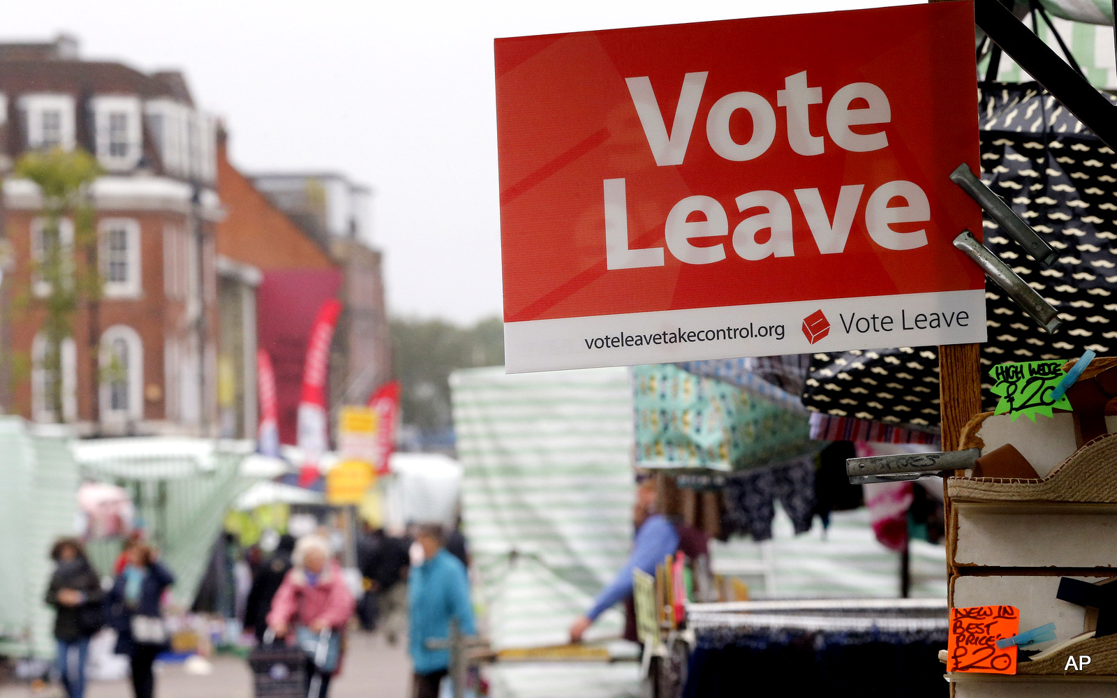 A Vote Leave sign is fixed on a market stall at Havering's Romford street market in London, Wednesday, June 1, 2016. 