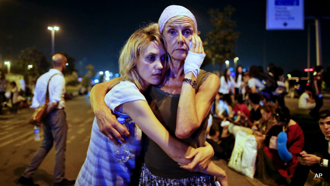 Passengers embrace each other as they wait outside Istanbul's Ataturk airport, early Wednesday, June 29, 2016 following their evacuation after a blast. Suspected ISIS extremists have hit the international terminal of Istanbul's Ataturk airport, killing dozens of people and wounding many others, Turkish officials said Tuesday. Turkish authorities have banned distribution of images relating to the Ataturk airport attack within Turkey.