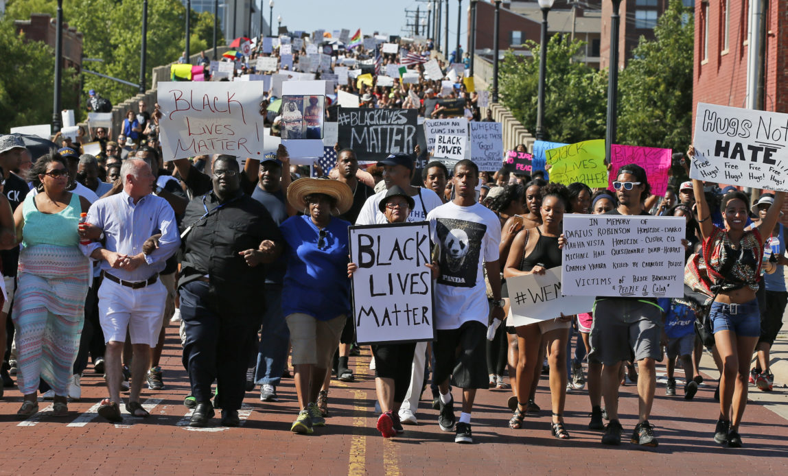People march in a Black Lives Matter rally in Oklahoma City, Sunday, July 10, 2016.