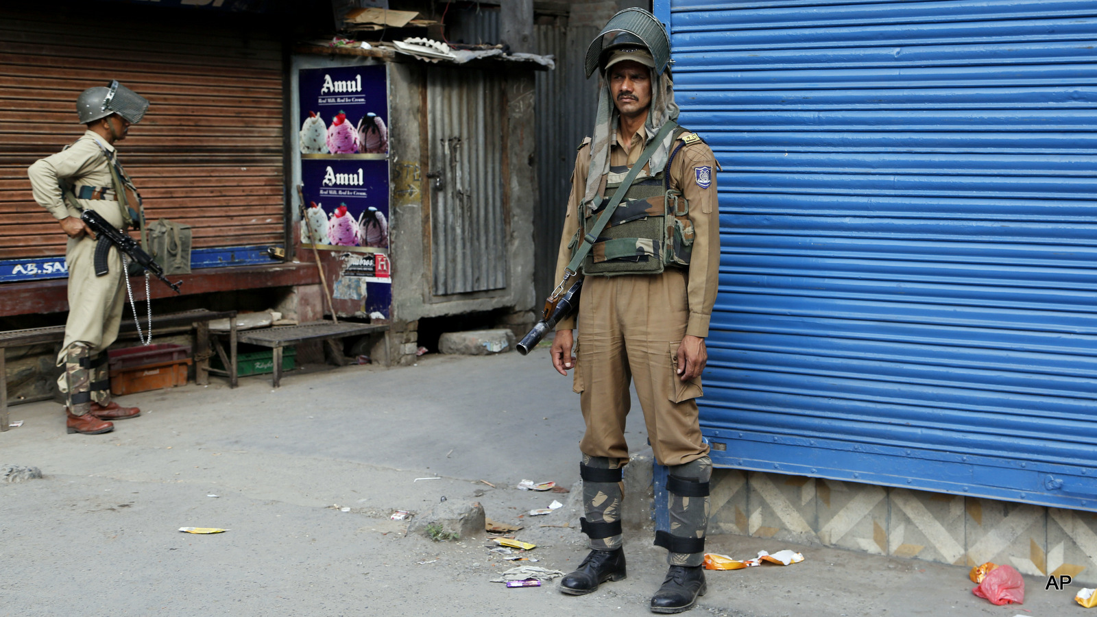 Indian paramilitary police stand guard during curfew in Srinagar, Indian occupied Kashmir, Wednesday, July 13, 2016.