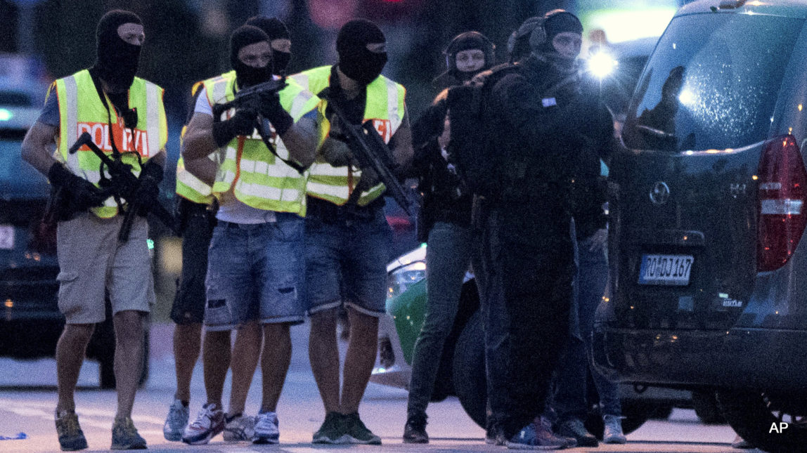 Special police forces prepare to search a neighboring shopping center outside the Olympia mall in Munich, southern Germany, Friday, July 22, 2016 after several people were killed in a shooting.