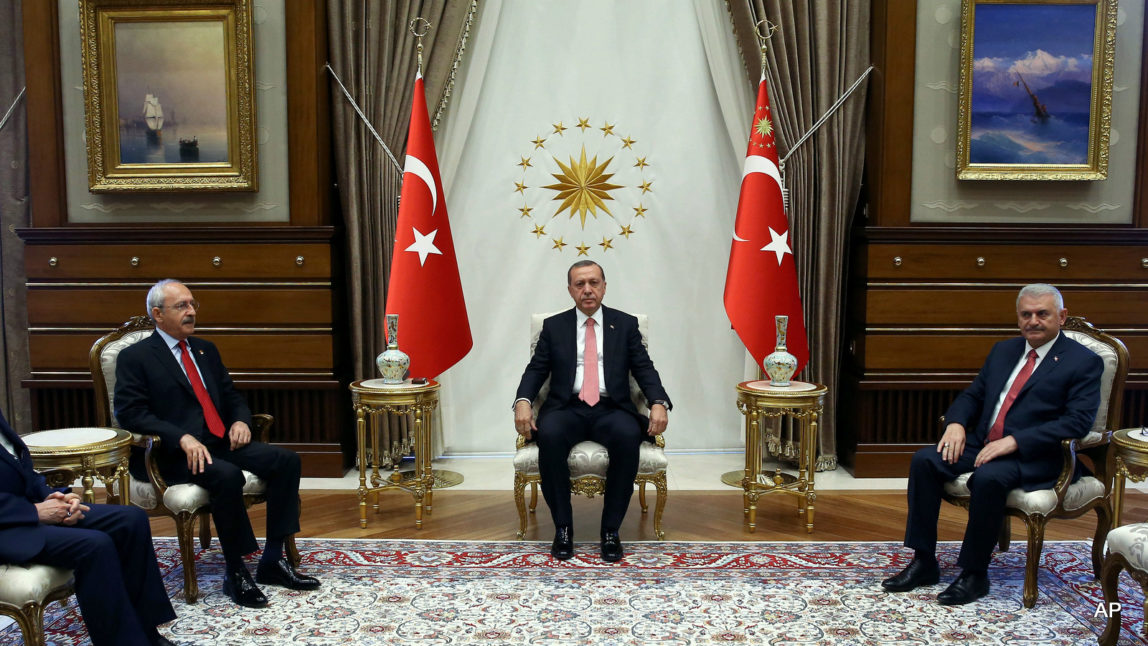 Turkey's President Recep Tayyip Erdogan, centre, Republican People's Party leader Kemal Kilicdaroglu, second left, National Movement Party leader Devlet Bahceli, left and Prime Minister Binali Yildirim look on at the start of their meeting in Ankara, Turkey, Monday, July 25, 2016.