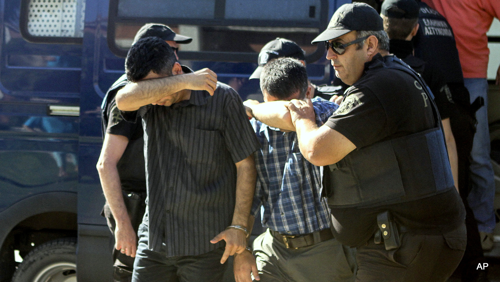 Turkish military personnel who were aboard a Blackhawk military helicopter are transferred to a prosecutor's office in the city of Alexandroupolis, northern Greece, Sunday July 17, 2016.