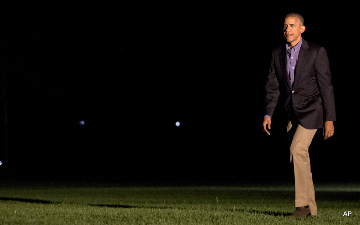 President Barack Obama returns from a shortened visit to Spain, as he walks across the South Lawn of the White House in Washington, Sunday, July 10, 2016.President Barack Obama returns from a shortened visit to Spain, as he walks across the South Lawn of the White House in Washington, Sunday, July 10, 2016.
