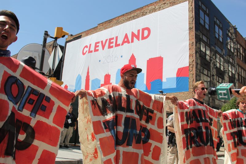 In this July 20, 2016 photograph, activists "Wall Off Trump" with special costumers, blocking access to the Quicken Loans Arena, site of the 2016 Republican National Convention. (MintPress News / Desiree Kane)