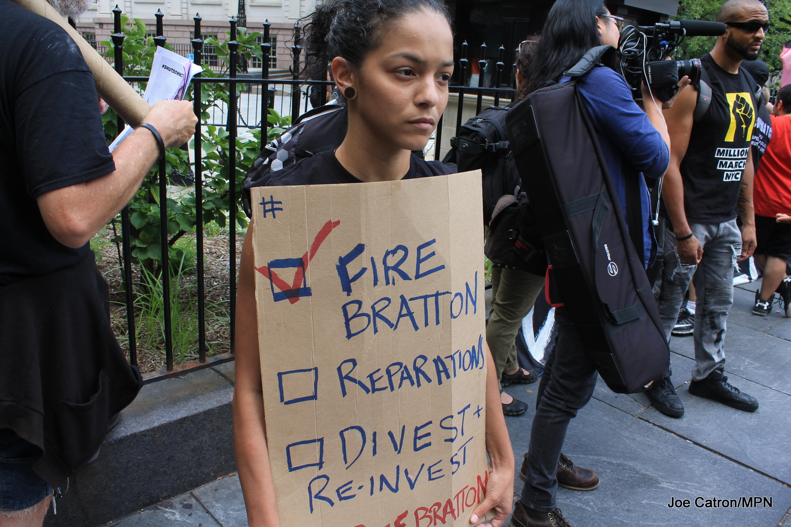 Participants in an ongoing occupation of City Hall Park celebrated the announced resignation of New York Police Department Commissioner Bill Bratton outside a City Hall press conference, August 2, 2016.