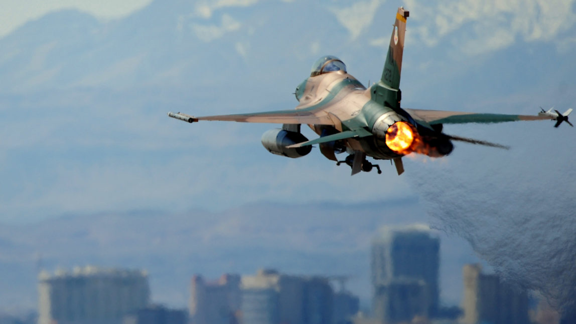 NELLIS AIR FORCE BASE, NEV. -- An F-16 Aggressor takes off from the Nellis flight line during a Red Flag Exercise, March 3, 2010. Red Flag is a realistic combat training exercise involving the air forces of the United States and its allies. The exercise is conducted on the 15,000-square-mile Nevada Test and Training Range, north of Las Vegas. (Photo: William Coleman/USAF)