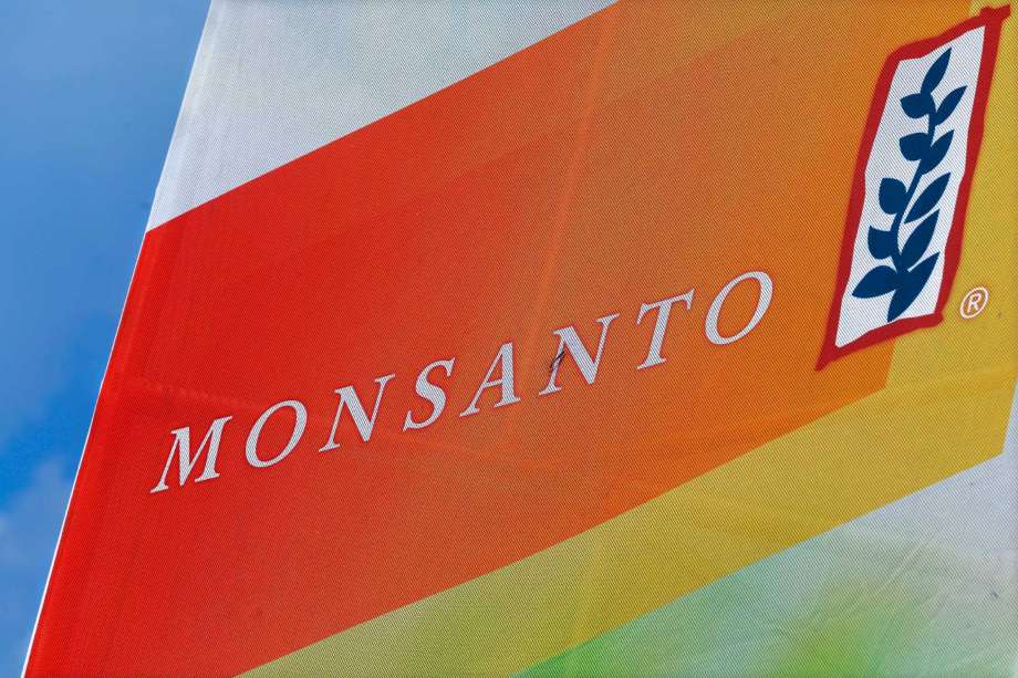 This Aug. 31, 2015, file photo, shows the Monsanto logo on display at the Farm Progress Show in Decatur, Ill. A former Monsanto Co. financial executive who tipped off regulators about the agribusiness giant's accounting practices involving rebates for its Roundup weed-killer will get nearly $22.5 million as a whistleblower, federal securities regulators announced Tuesday, Aug. 30, 2016