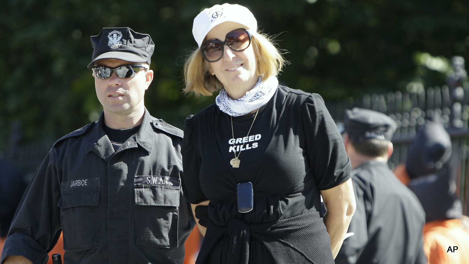 Cindy Sheehan is taken into custody by a United States Park Police officer during a demonstration in front of the White House in Washington, Monday, Oct. 5, 2009.