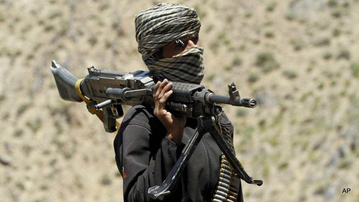 A Taliban fighter guards a gathering in Shindand district of Herat province, Afghanistan.