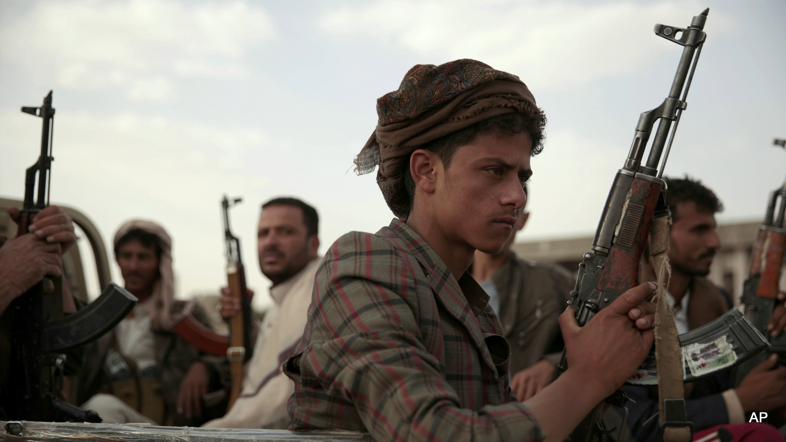 Houthi rebels ride on a pickup truck as they attend a gathering aimed at mobilizing more fighters into battlefronts in several Yemeni cities, in Sanaa, Yemen. June 20, 2016.