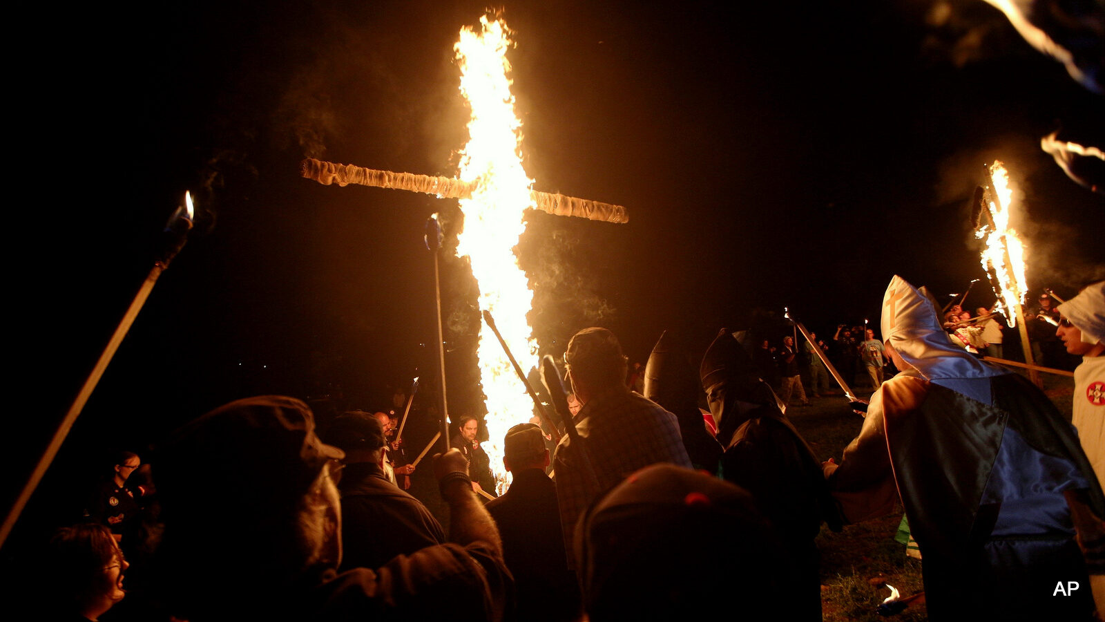 Members of the Ku Klux Klan participate in cross burnings after a "White Pride," rally, in rural Paulding County near Cedar Town, Ga. The Ku Klux Klan is trying to raise its hooded head 150 years after it was founded following the Civil War.