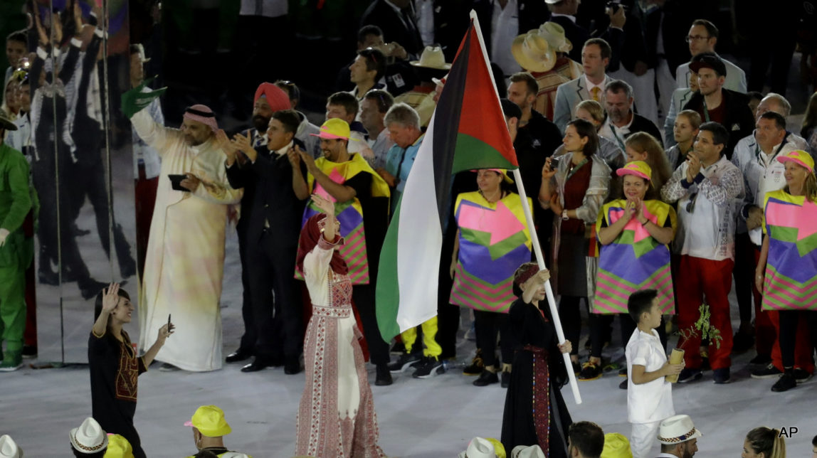 Mayada Al-Sayed carries the flag of Palestine during the opening ceremony for the 2016 Summer Olympics in Rio de Janeiro, Brazil, Friday, Aug. 5, 2016.