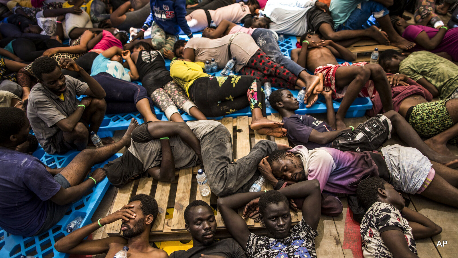 Migrants from Nigeria and Ivory Coast rest on a vessel after being rescued by a Migrant Offshore Aid Station, MOAS team in the central Mediterranean Sea, close to the Libyan territorial waters. Aug. 10, 2016