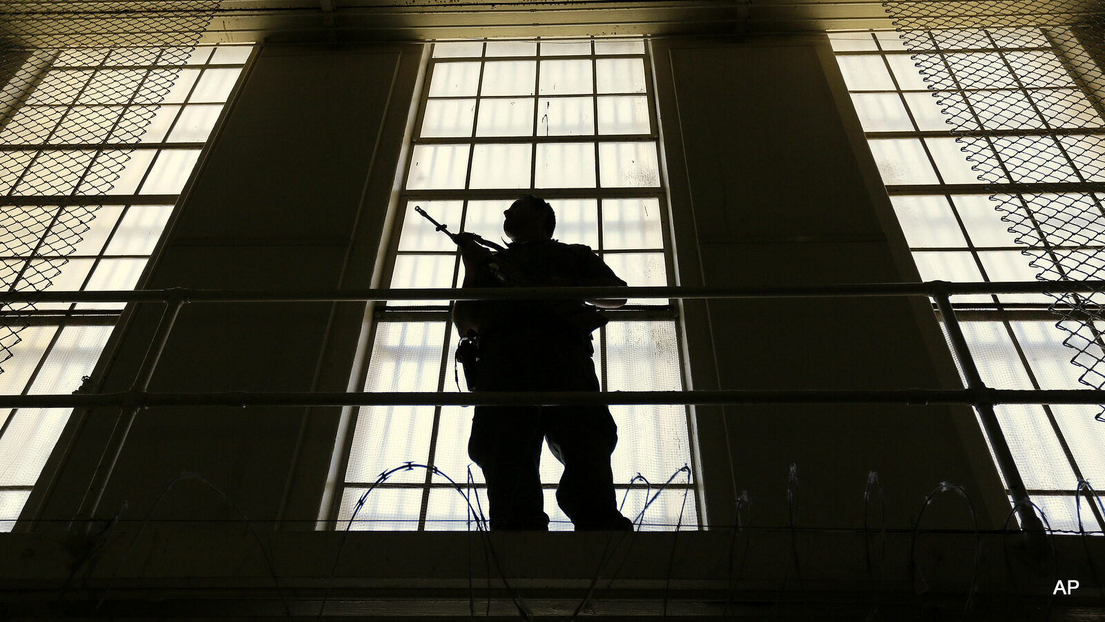 A guard stands watch over the east block of death row at San Quentin State Prison Tuesday, Aug. 16, 2016, in San Quentin, Calif. A pair of November ballot measures will decide the future of the death penalty in California. As of Aug. 1, 2016, there were 700 condemned inmates at the prison.