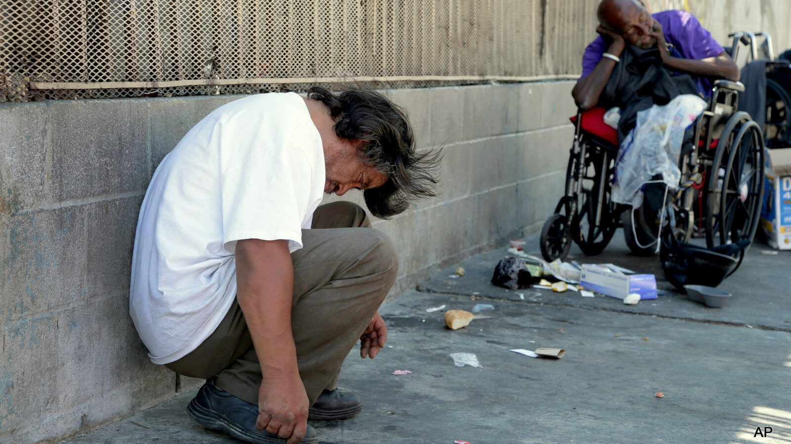 Homeless people rest in the Skid Row section of Los Angeles, Friday, Aug. 19, 2016.