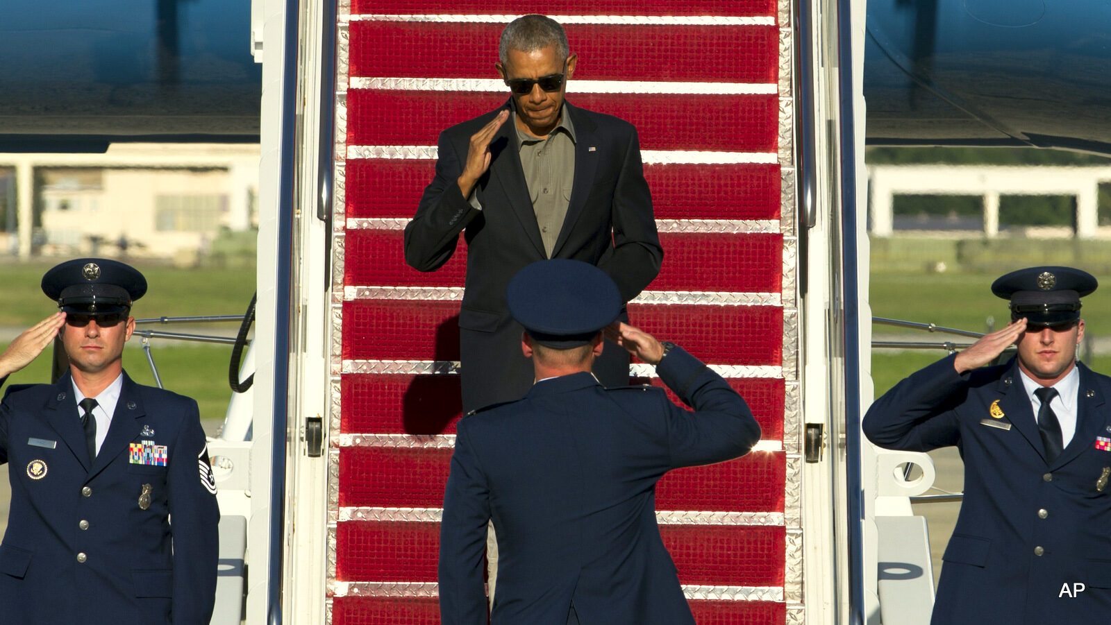 President Barack Obama salutes as he walks down the stairs from Air Force One upon his arrival at Andrews Air Force Base, Aug. 23, 2016.