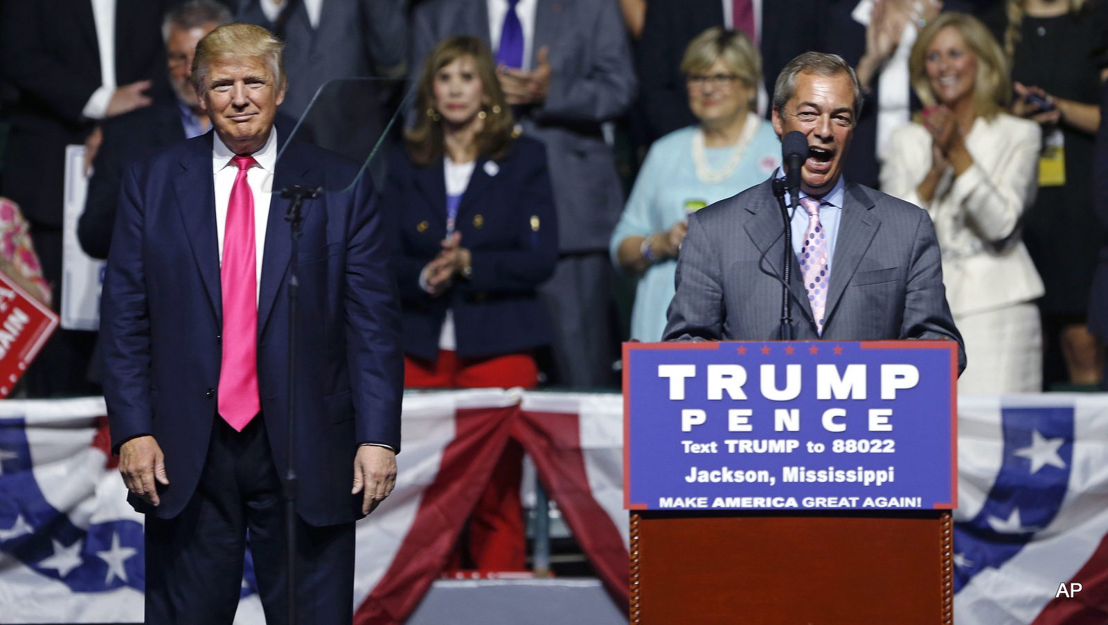 Nigel Farage, ex-leader of the British UKIP party, speaks as Republican presidential candidate Donald Trump, left, listens, at Trump's campaign rally in Jackson, Miss., Wednesday, Aug. 24, 2016.