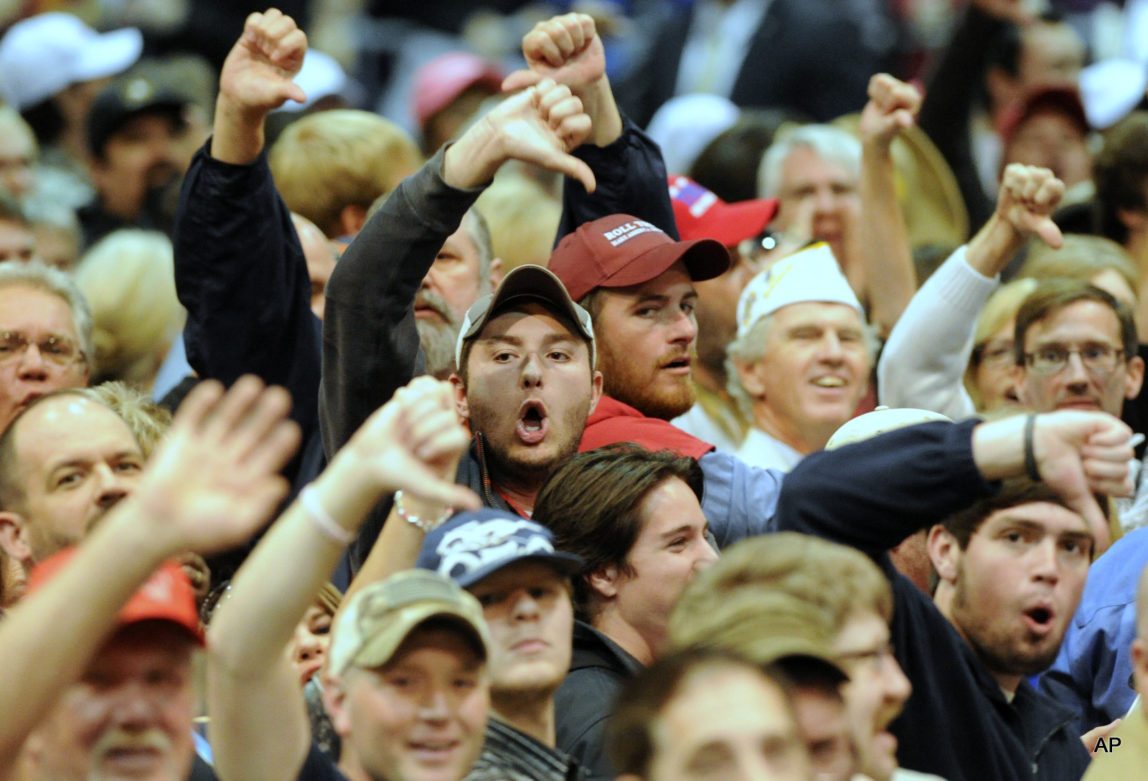 Trump supporters 'boo' the media after a Black Lives Matter protester was removed as Republican presidential candidate Donald Trump spoke during a campaign stop in Birmingham, Ala.