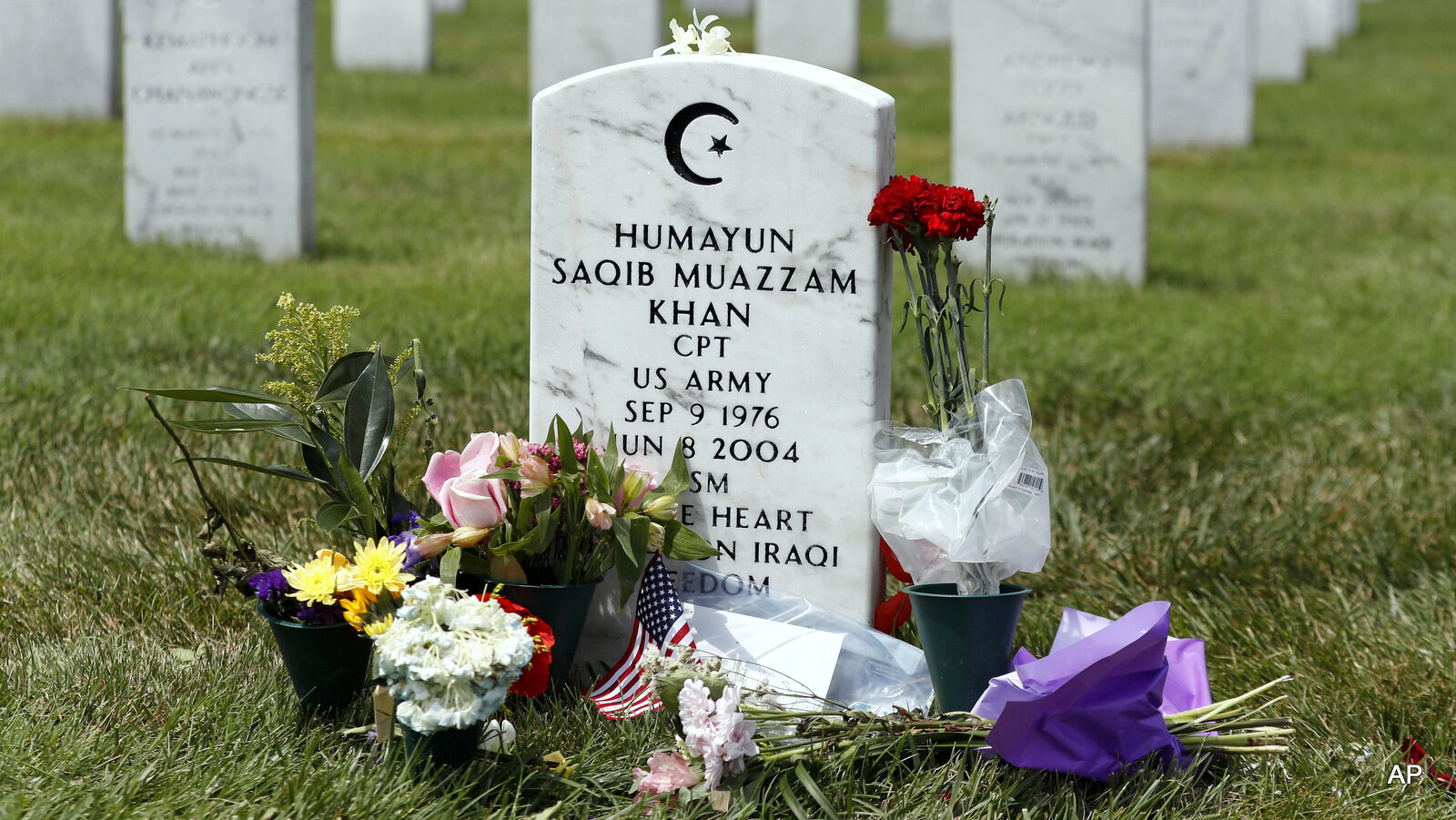 The tombstone of US Army Capt. Humayun S. M. Khan is seen in Section 60 at Arlington National Cemetery in Arlington, Va., Monday, Aug. 1, 2016. Fellow Republicans are joining the rising chorus of criticism of Donald Trump for his disparagement of the bereaved parents of U.S. Army Capt. Humayun Khan, a Muslim who was awarded a Bronze Star after he was killed in 2004 in Iraq.