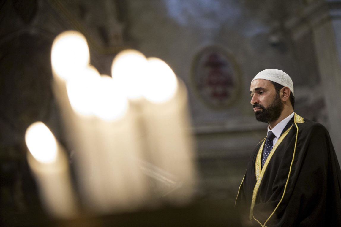 Imam Sami Salem delivers his speech during a Mass in Rome's Saint Mary in Trastevere church, Italy, Sunday, July 31, 2016. Imams and practicing Muslims attended Mass across Italy, from Palermo in the south to Milan in the north, in a sign of solidarity after the France church attack in which an elderly priest was slain.