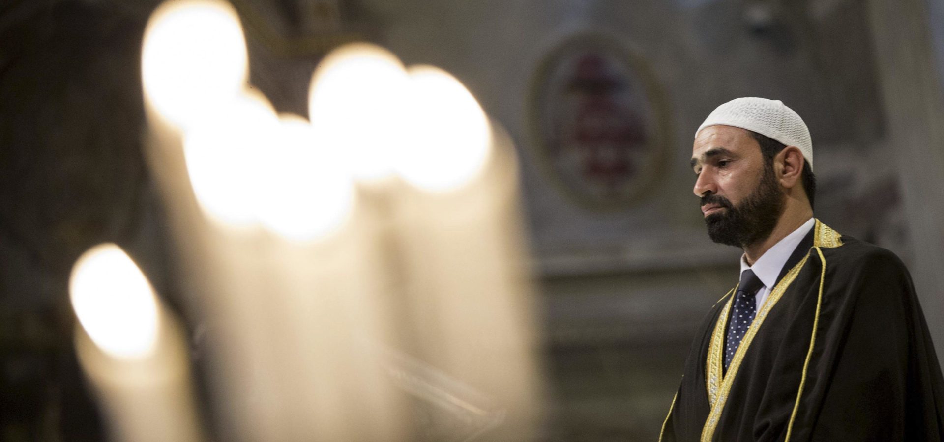 Imam Sami Salem delivers his speech during a Mass in Rome's Saint Mary in Trastevere church, Italy, Sunday, July 31, 2016. Imams and practicing Muslims attended Mass across Italy, from Palermo in the south to Milan in the north, in a sign of solidarity after the France church attack in which an elderly priest was slain.