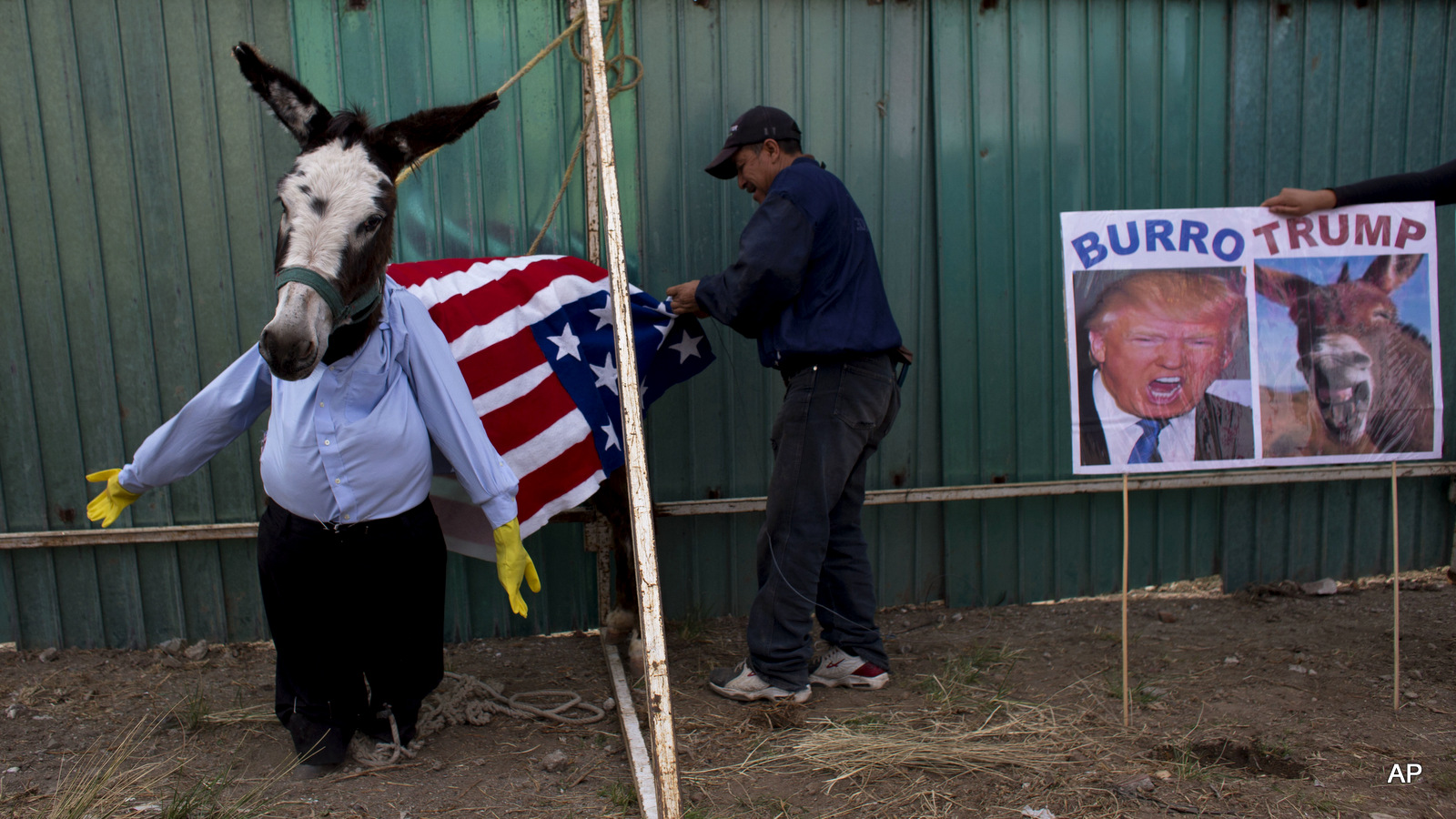 A man dresses a donkey to resemble Donald Trump in preparation for the costume competition at the annual donkey festival in Otumba, Mexico state, Mexico