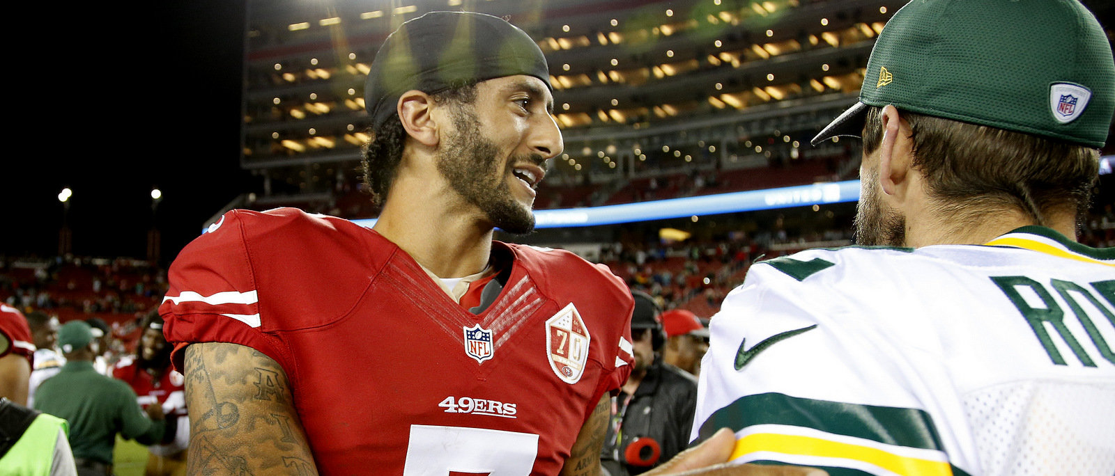 San Francisco 49ers quarterback Colin Kaepernick, left, greets Green Bay Packers quarterback Aaron Rodgers at the end of an NFL preseason football game Friday, Aug. 26, 2016, in Santa Clara, Calif.