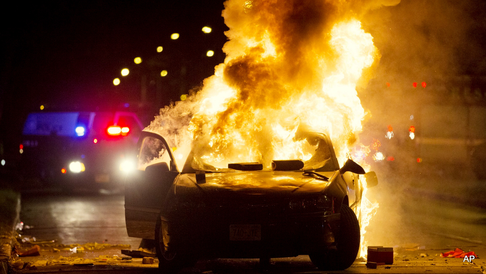 Fire in Milwaukee as protesters burned cars and set a gas station ablaze over the police shooting of a Black man in the city on Saturday Aug. 13, 2016.