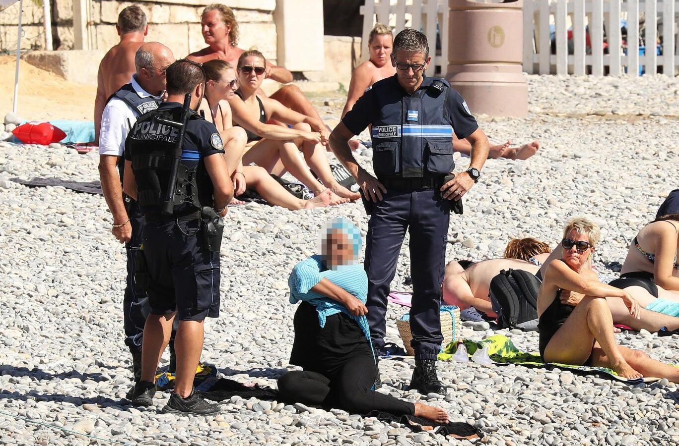 Christian Estrosi, A right-wing French official, has threatened suit against anyone who publishes images such as this, French Police forcing a women to disrobe at a Nice beach.