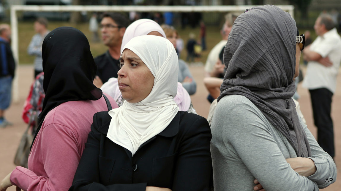 Residents gather in a town park for a solemn homage to the Rev. Jacques Hamel in Saint-Etienne-du-Rouvray, Normandy, France, Thursday, July 28, 2016. Saint-Etienne's mayor Hubert Wulfranc called for a solemn homage to the Rev. Jacques Hamel on Thursday, for a moment of silence followed by the French national anthem.