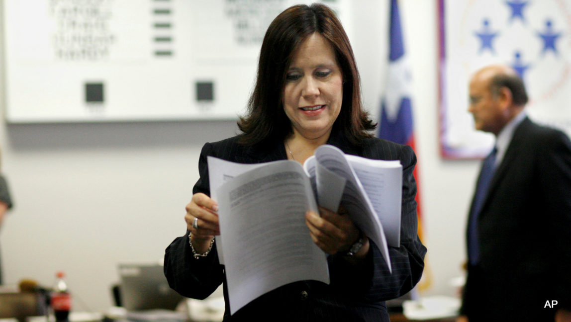 Cynthia Dunbar, from Richmond, studies a curriculum version during a break in the meeting of the State Board of Education Friday, May 23, 2008, in Austin, Texas.