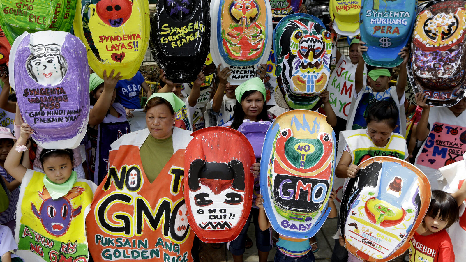 Mothers and children display painted baby tubs which they themselves designed during a protest on World Environment Day Wednesday June 5, 2013 at suburban Quezon city northeast of Manila, Philippines. The mothers have formed a coalition called "Green Moms" advocating organic foods and breastfeeding practices to show their opposition to a genetically modified rice variety known as "Golden Rice" which allegedly is being promoted by GMO (Genetically Modified Organisms) proponents as a quick fix solution to a Vitamin A Deficiency or VAD especially for new-born babies and lactating mothers.
