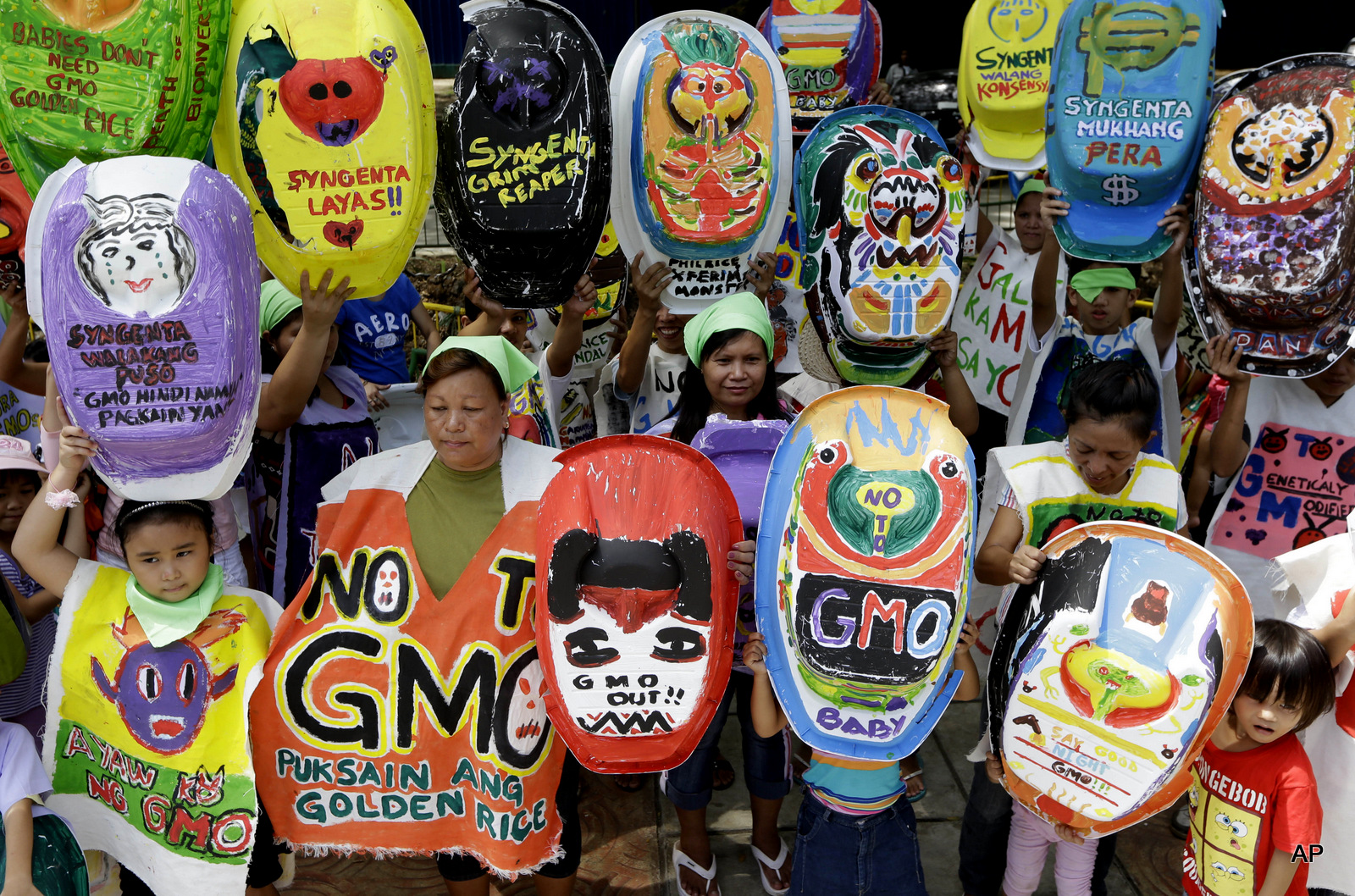Mothers and children display painted baby tubs which they themselves designed during a protest on World Environment Day Wednesday June 5, 2013 at suburban Quezon city northeast of Manila, Philippines. The mothers have formed a coalition called "Green Moms" advocating organic foods and breastfeeding practices to show their opposition to a genetically modified rice variety known as "Golden Rice" which allegedly is being promoted by GMO (Genetically Modified Organisms) proponents as a quick fix solution to a Vitamin A Deficiency or VAD especially for new-born babies and lactating mothers.