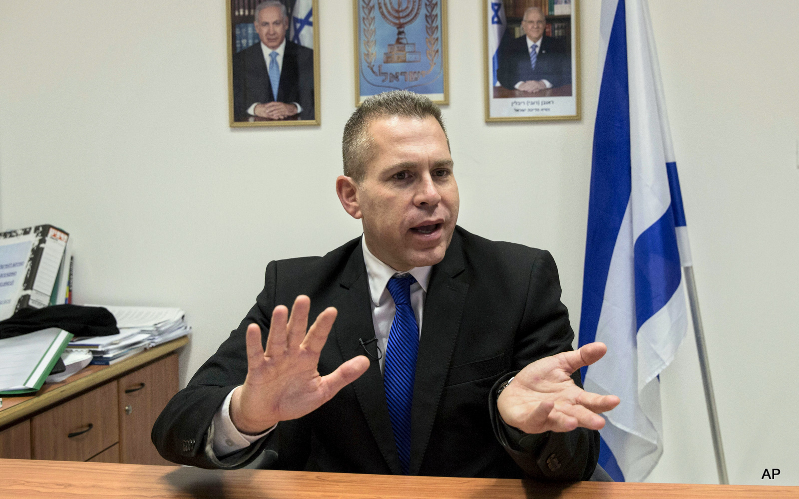 In this Thursday, July 14, 2016 photo, Israeli Public Security Minister Gilad Erdan speaks during an interview with The Associated Press in his office in Tel Aviv, Israel.