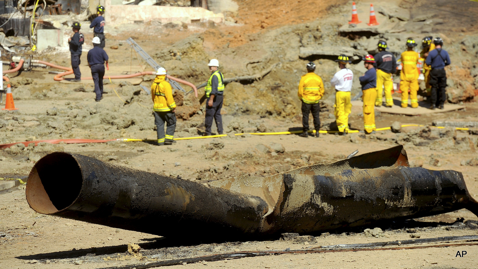 FILE - In this Sept. 11, 2010, file photo, a natural gas line lies broken on a San Bruno, Calif., road after a massive explosion. The blast of a Pacific Gas & Electric Co. natural gas pipeline sent a giant plume of fire into the air in a neighborhood in San Bruno, killing eight people and destroying 38 homes.
