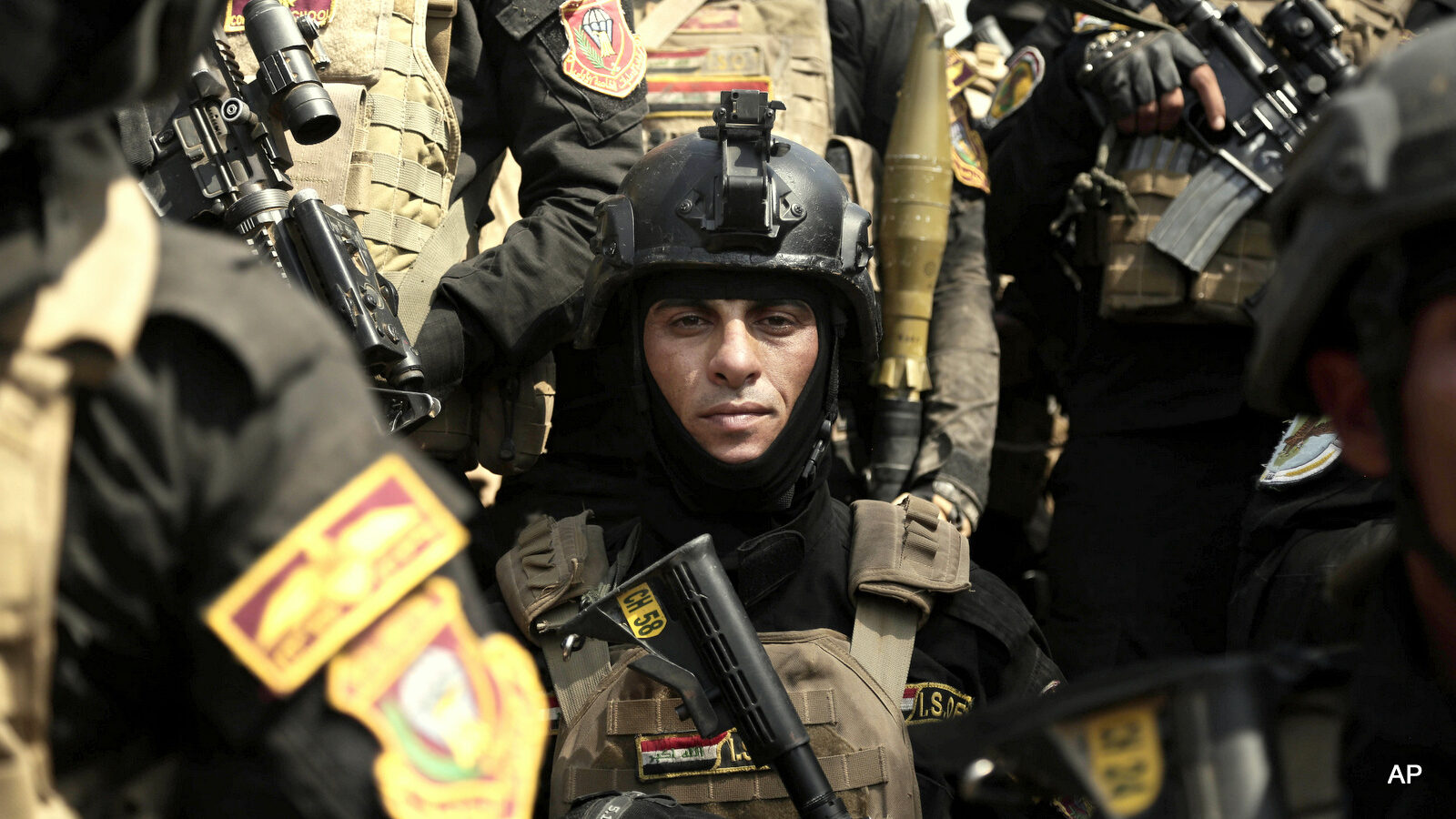 A soldier from the 1st Battalion of the Iraqi Special Operations Forces listens to an address by his commander after a training exercise to prepare for the operation to re-take Mosul from ISIS militants, in Baghdad, Iraq.