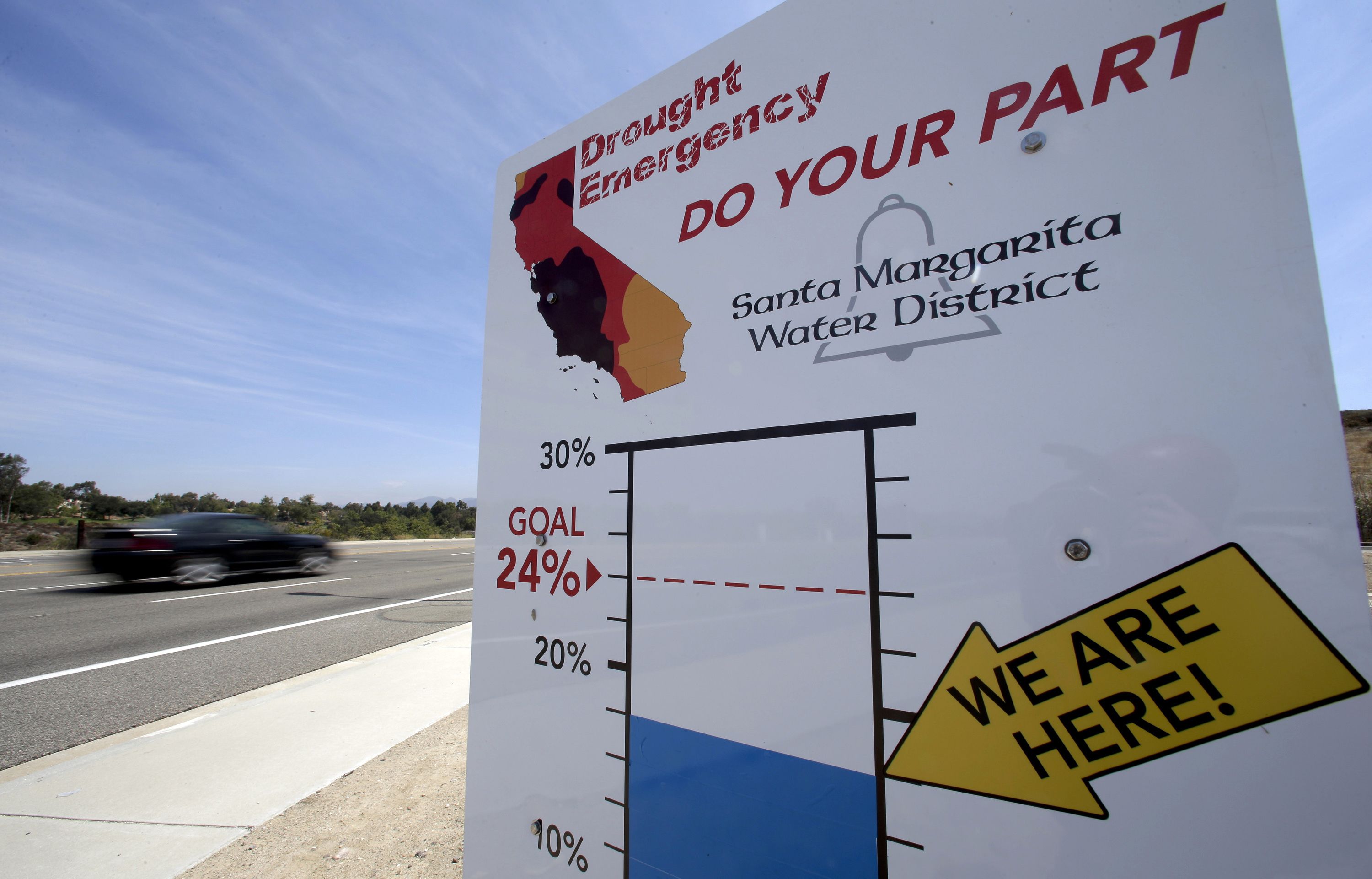Cars in Rancho Santa Margarita, Calif., drive by a sign encouraging residents to save water, July 2, 2015.