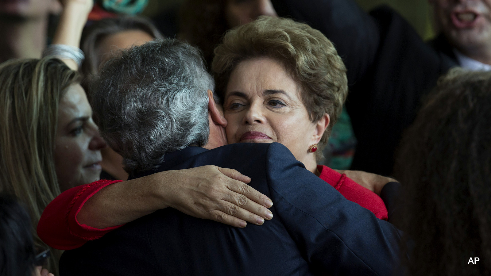 Brazil's ousted President Dilma Rousseff is embraced by the senator Jorge Viana, after she addressed supporters from the official residence of the president, Alvorada Palace in Brasilia, Brazil, Wednesday, Aug. 31, 2016.