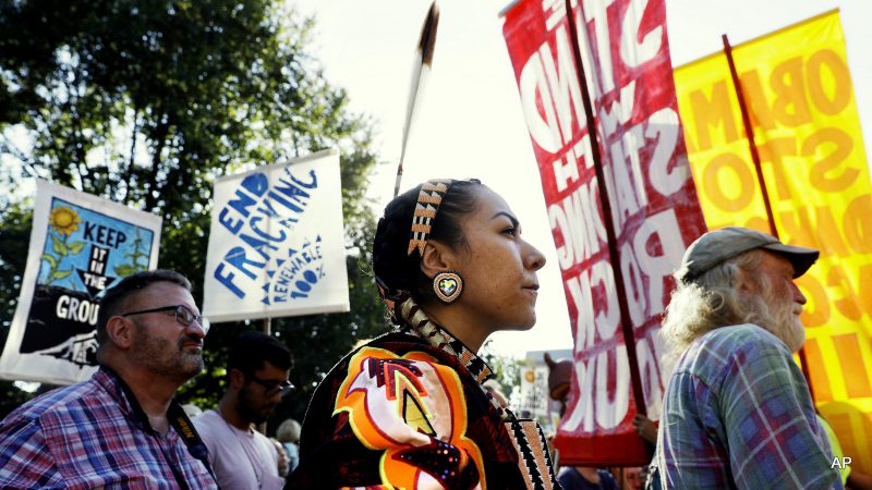 Angela Miracle Gladue, center, a member of the Frog Lake First Nations, a Cree community in Edmonton, Alberta, Canada, attends a rally in support of the Standing Rock Sioux Tribe and in opposition of the Dakota Access oil pipeline, in Lafayette Park near the White House, Tuesday, Sept. 13, 2016, in Washington.