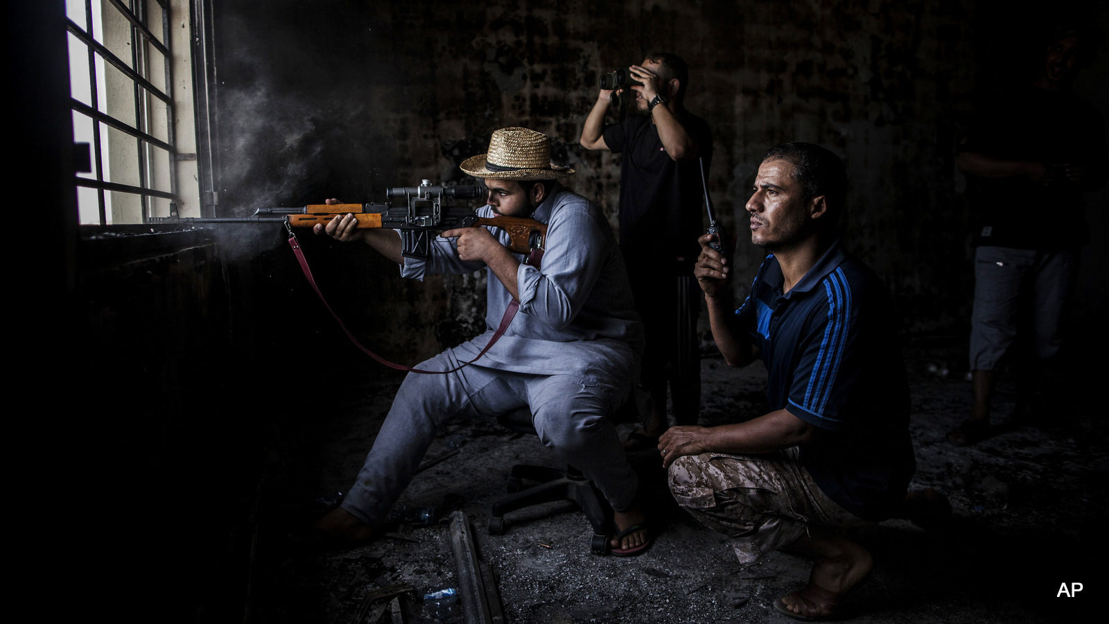 A sniper from Misrata fires towards ISIS militant positions in Sirte, Libya, Wednesday, Sept. 21, 2016.