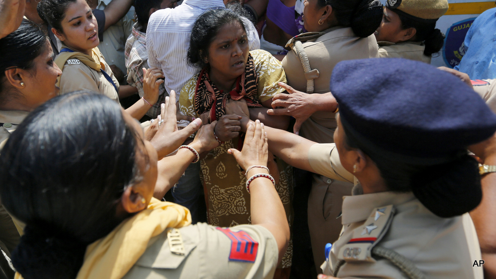 Indian policewomen detain a sanitation worker during a protest in Ahmadabad, India, Tuesday, Sept. 27, 2016. The protestors demanded permanent jobs for sanitation workers who had been employed on contract basis for several years in the Ahmadabad Municipal Corporation.