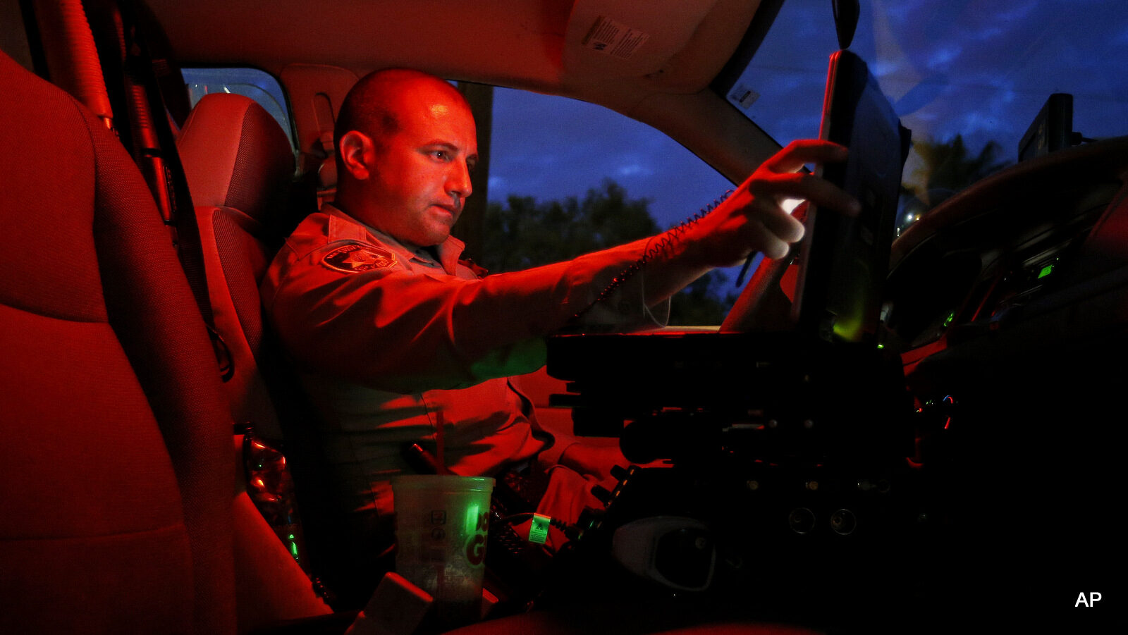 A Las Vegas police officer looks at the computer in his cruiser while working on a swing shift in downtown Las Vegas.