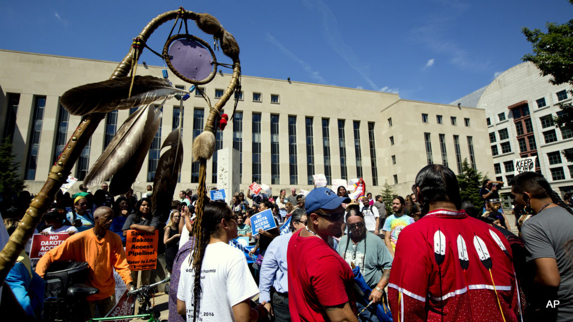 An Eagle Staff is held up as Native Americans gather during a rally outside U.S. District Court in Washington, Wednesday, Aug. 24, 2016, in solidarity with the Standing Rock Sioux Tribe in their lawsuit against the Army Corps of Engineers to protect their water and land from the Dakota Access Pipeline. A federal judge in Washington considered a request by the Standing Rock Sioux for a temporary injunction against an oil pipeline under construction near their reservation straddling the North Dakota-South Dakota border.