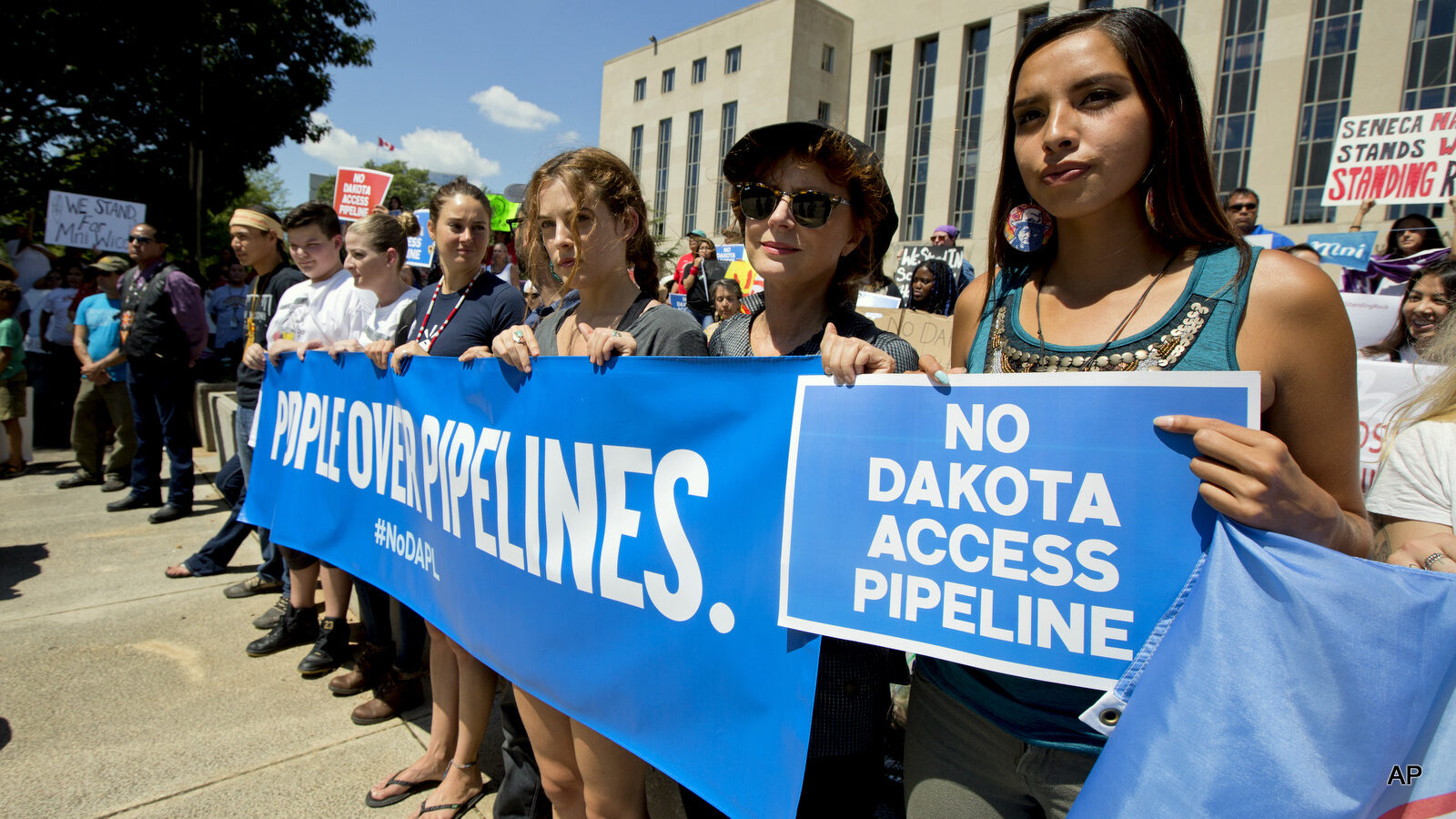 Actress Shailene Woodley, fourth from right to right, Riley Keough the eldest grandchild of Elvis and Priscilla Presley, actress Susan Sarandon and Standing Rock Sioux Tribe member Bobbi Jean Three Lakes, right, participate in a rally outside the US District Court in Washington, Wednesday, Aug. 24, 2016, in solidarity with the Standing Rock Sioux Tribe in their lawsuit against the Army Corps of Engineers to protect their water and land from the Dakota Access Pipeline.
