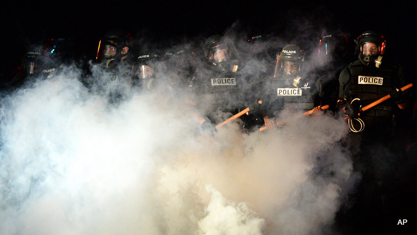 Police stand in formation in Charlotte, N.C., Tuesday, Sept. 20, 2016. Authorities used tear gas to disperse protesters in an overnight demonstration that broke out Tuesday after Keith Lamont Scott was fatally shot by an officer at an apartment complex.