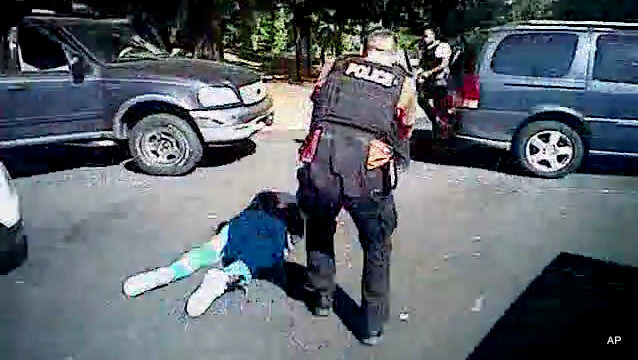 This image made from video provided by the Charlotte-Mecklenburg Police Department on Saturday, Sept. 24, 2016 shows Keith Scott on the ground as police approach him in Charlotte, N.C., on Sept. 20, 2016.